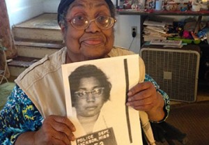 Lula White of New Haven holds the mug shot from her 1961 arrest.
